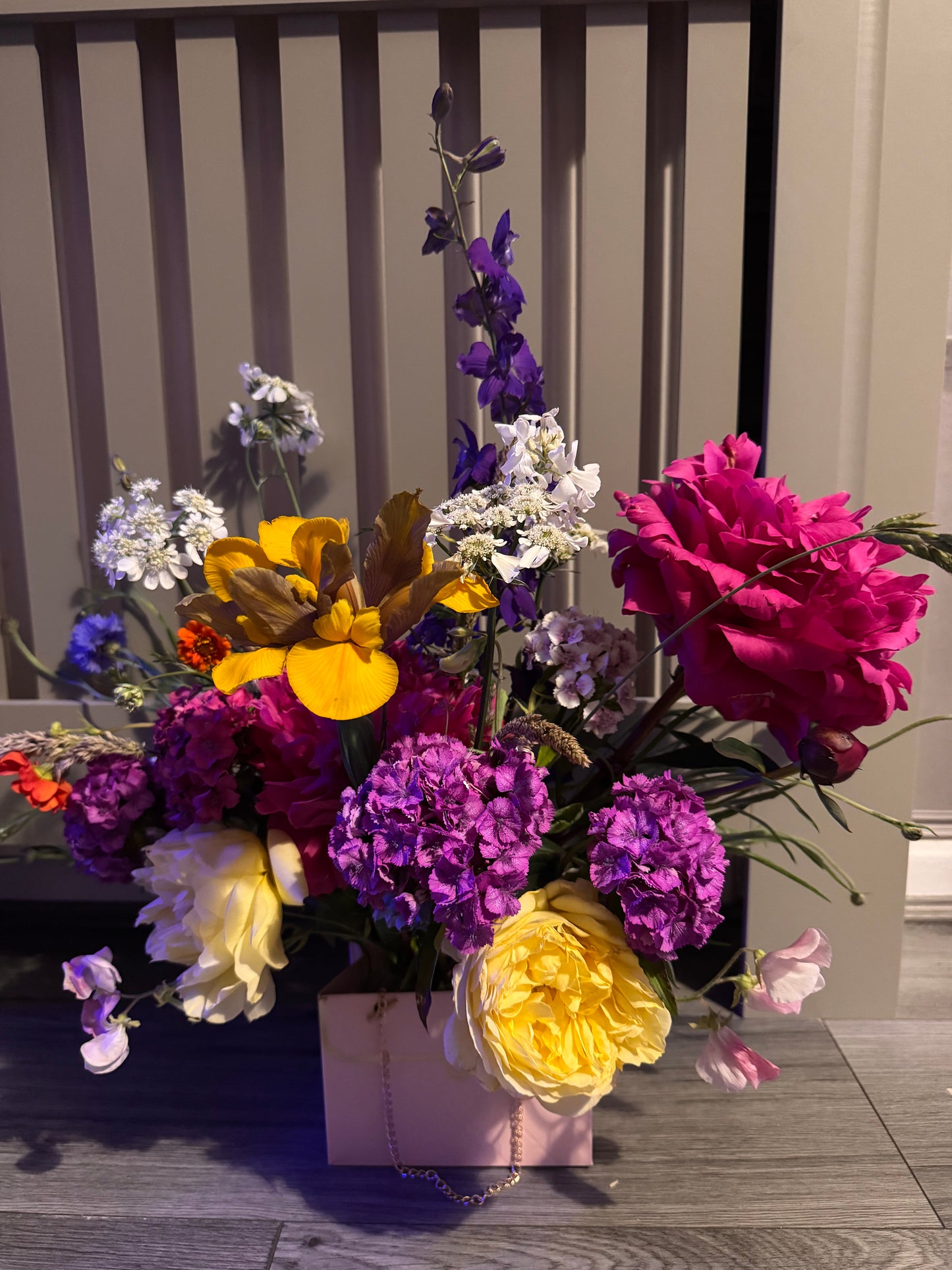 Beautiful fresh flower arrangement in pink handbag display