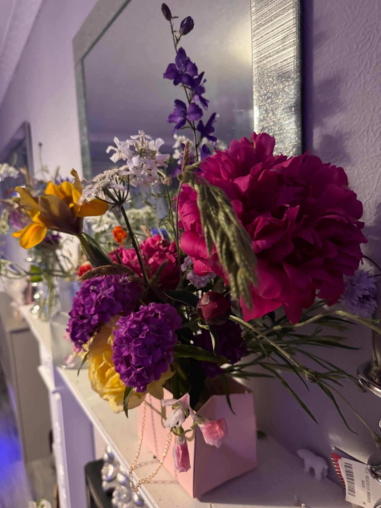 Beautiful fresh flower arrangement in pink handbag display